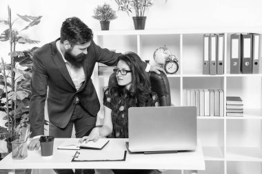 Oridinary working day. Businessman and businesswoman at workplace. Serious office employees. Working relations. Managers work on project.