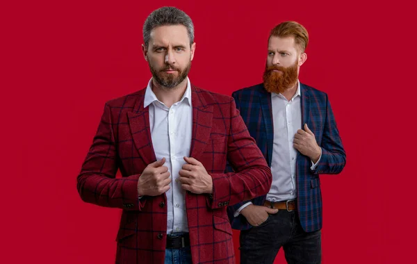 photo of ambitious formal elegant men in formalwear. formal elegant men isolated on red. formal elegant men at studio. formal elegant men on background.