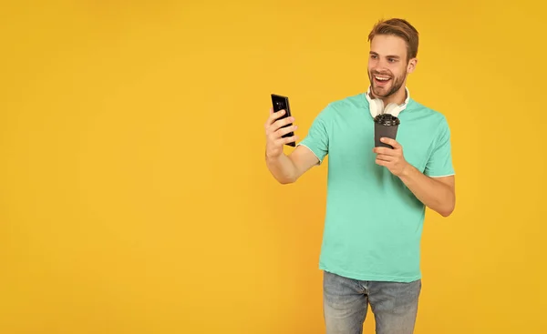 Happy Unshaven Young Man Drink Coffe Making Selfie Phone Yellow — Stockfoto