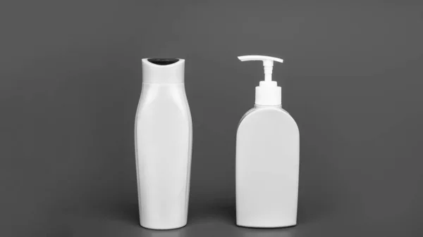 Meeting your needs to store cosmetic liquids. Shampoo and conditioner bottles. Toiletry bottles blue background. Refillable containers. For beauty products, copy space.