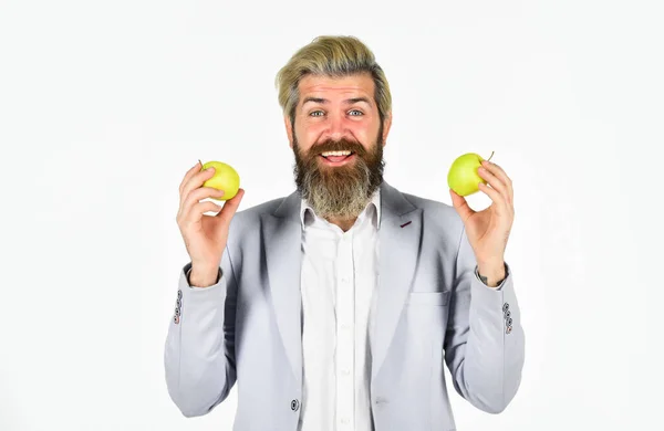 stock image Fruit harvest. Successful businessman holding an apple. Business lunch. Education business. Cheerful smiling man with apples. Harvesting business. Apple became symbol for knowledge. Vitamin and diet.