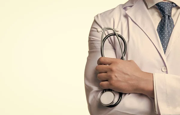 Healthcare worker crop view. Healthcare practitioner holding stethoscope. Healthcare professional in white coat. Medical service. Medicare, copy space.