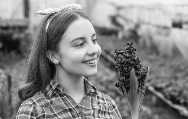 happy teen girl florist care pot plants in greenhouse, gardener.