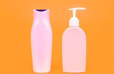 Banyo malzemelerini paketlemek için mükemmel. Şampuan ve saç kremi şişeleri. Kozmetik şişeleri sarı arka plan. Tuvalet malzemesi paketi. Sıvı konteynırlar. Güzellik ürünleri için, kopyalama alanı.