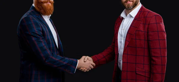 cropped view of men deal with handshake at studio. men deal with handshake on background. photo of men deal with handshake. men deal with handshake isolated on black.