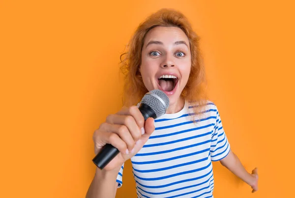 stock image cheerful karaoke woman singer isolated on yellow background. young singer woman sing in karaoke studio. woman karaoke singer with microphone.