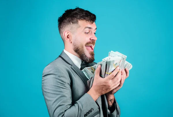 Businessman got cash money. Gain real money. Richness and wellbeing concept. Cash transaction business. Easy cash loan. Man formal suit hold many dollar banknotes blue background. Take my money.