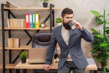Stop and sip the coffee. Professional man drink coffee in office. Rest break. Work break. Taking some time off.