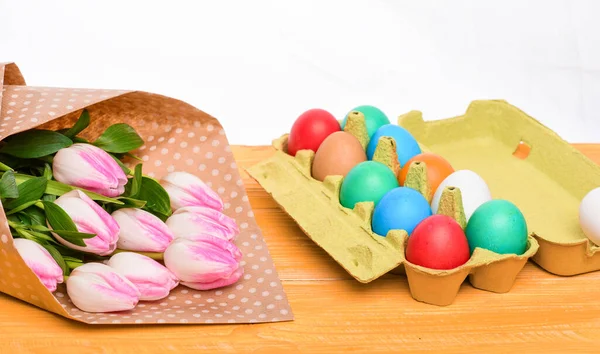 Tulip flower bouquet. Healthy and happy holiday. painted eggs in egg tray. Spring holiday. Holiday celebration, preparation. Happy easter. Egg hunt. Easter menu.