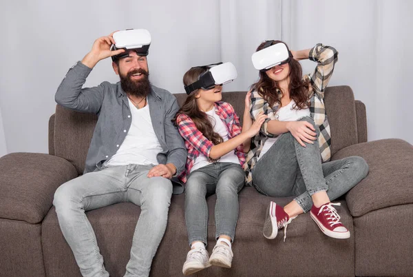 stock image virtual reality family. happy parents with kid girl use modern technology. mom dad and daughter. digital future and innovation. father mother and child wireless VR glasses.