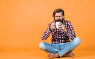 Hold cup of coffee or tea. lifestyle concept. handsome hipster man with cup of coffee. he is taking a coffee break. Handsome mature guy drinking from cup.