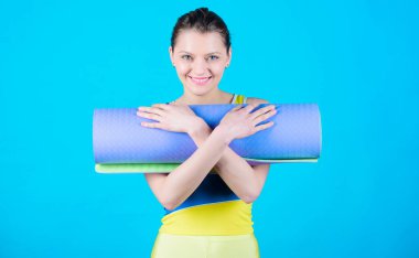 İnce gülümseyen kız atlet tutun fitness mat uygun. Fitness ve germe. Kas germe. Yoga oluk içine almak. Yoga hobi ve spor olarak. Yoga sınıf kavramı. Her gün pratik Yoga.