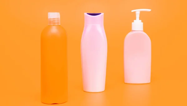 Liquid Plastic Containers Shampoo Bodywash Cosmetic Products Toiletries Yellow Background — Fotografia de Stock