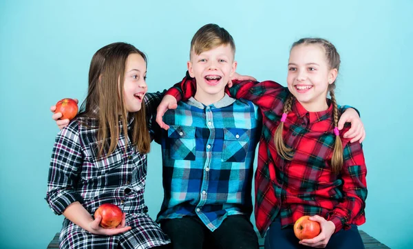 Having joyful feelings and positive emotions. Happy children. Happy little kids laughing and smiling together. Happy small girls and boy holding red apples. Enjoying happy childhood.