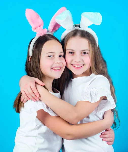 Spring holiday. Happy childhood. Friendship concept. Easter vibes. Happy easter. Holiday bunny girls with long bunny ears hug. Children easter bunny costume. Playful girls sisters celebrate easter.