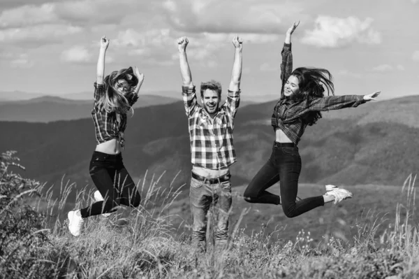 Happy weekend. Reached top. Happy cheerful friends celebrate reaching top mountain. Feeling freedom. Man and girls happy emotional expression. Summer vacation in mountains. Hikers excited about hike.