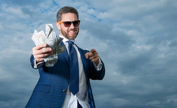 richness photo of man with money, copy space. richness of man with money on sky background. richness of man with money outdoor. richness of man with money in suit.