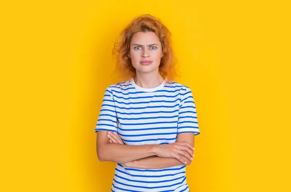 confused redhead woman portrait isolated on yellow background. portrait of young redhead woman in studio. adult redhead woman portrait.