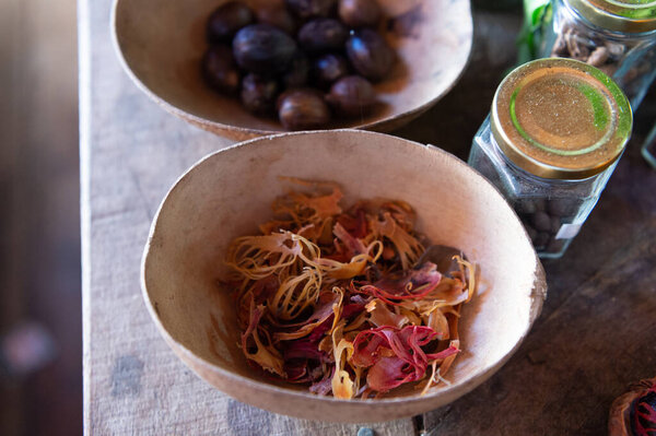 Nutmeg and mace spices. Organic mace in bowl. Mace spice crops. Whole mace. Agriculture.