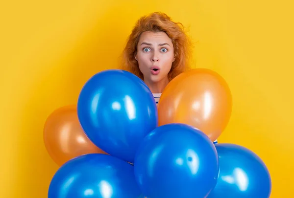 stock image happy birthday girl hold balloons in studio. shocked girl with balloon for birthday party isolated on yellow background. birthday party girl.