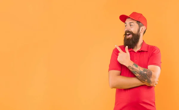 Happy Bearded Guy Casual Red Cap Tshirt Pointing Finger Aside — Foto Stock