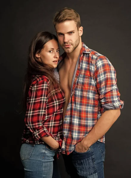 relationship of sexy girl and guy on black background, fashion.