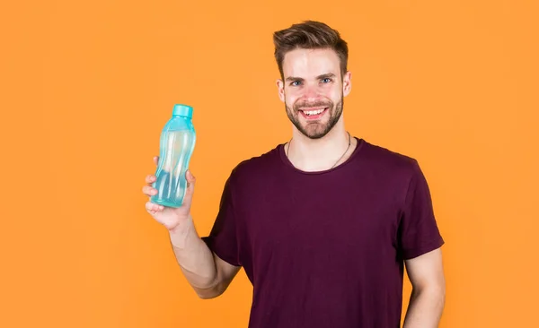 stock image helps skin glow. Handsome Young Man With Fit Body Drinking Fresh Water. Thirsty fitness male enjoying refreshing drink. concept of drinking water benefits. man drinking water. Drinking water.