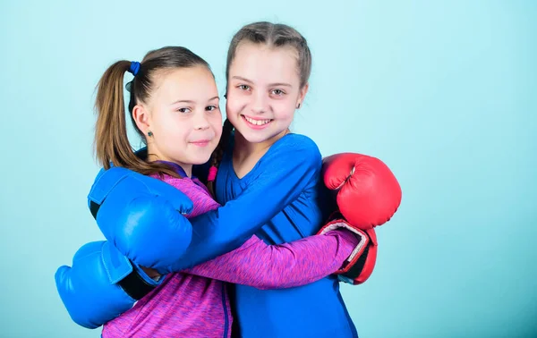 punching knockout. Childhood activity. workout of small girls boxer in sportswear. Sport success. Friendship. Fitness diet. energy health. Happy children sportsman in boxing gloves. we are the best.