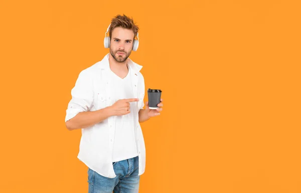 Man White Tshirt Wear Earphones Point Finger Coffee Cup Yellow — Stock Photo, Image