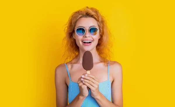 happy woman with icecream isolated on yellow. woman with icecream in studio. woman with icecream on background. photo of woman with icecream at summer.