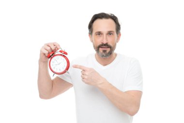 man with alarm clock in studio, point finger. man with alarm clock on background. photo of man with alarm clock. man with alarm clock isolated on white.