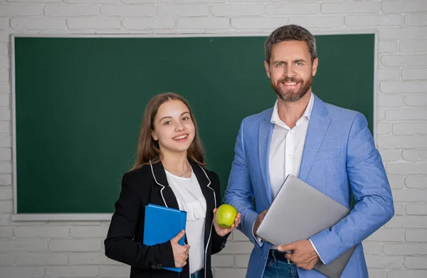 Stock image cheerful girl with man teacher in classroom. education.