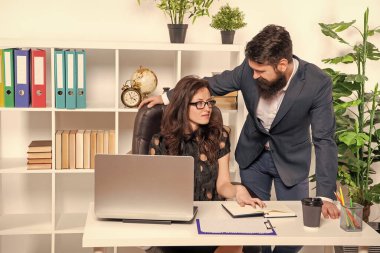 Oridinary working day. Businessman and businesswoman at workplace. Serious office employees. Working relations. Managers work on project.