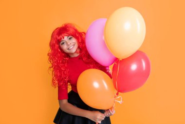 glad kid with party balloon on yellow background.