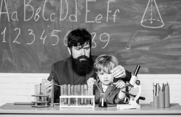 bearded man teacher with little boy. biotechnoloy research concept. Chemistry and physics biology. Back to school. Explaining biology to child. father and son at school. family bonding.