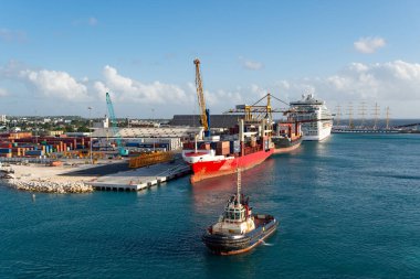 Bridgetown, Barbados - December 12, 2015: cargo barge ship with container in berth. clipart