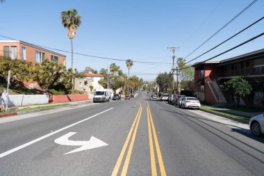 Long Beach, California USA - April 01, 2021: road marks on street in suburban neighborhood with parked cars.