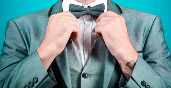 esthete. stylish art director. businessman fix bow tie. illusionist. Bride groom ready for wedding. business man in formal suit. PR manager make his style. Tying a bow tie. Close-up on nerd.