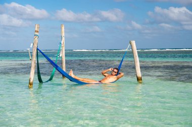 Yaz plajında rahatlayan bir kadın görüntüsü. Kadınlar yaz kumsalında dinlenir. Kadınlar tatilde yaz kumsalında dinlenirler. Kadınlar yaz plajında hamakta dinlenirler..