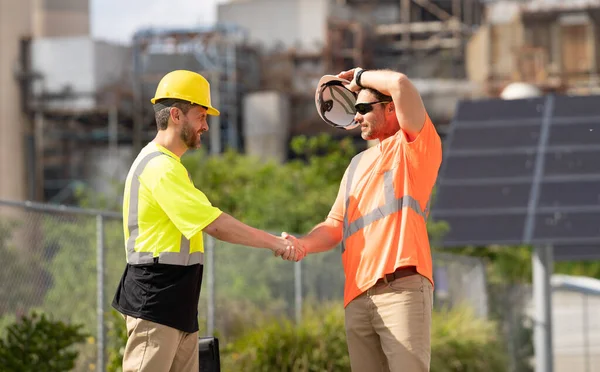 image of construction supervisor handshaking deal. construction supervisor handshaking deal. construction supervisor handshaking deal at site. construction supervisor handshaking deal outdoor.