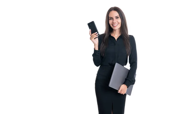 Happy boss holding mobile phone and laptop. Woman boss user of mobile and computing devices. Female boss using mobile technology for business communication, copy space.