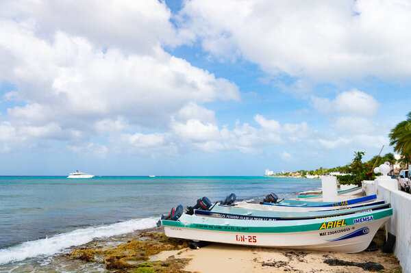 Cozumel, Mexico - December 24, 2015: boat on summer beach vacation with seafront.