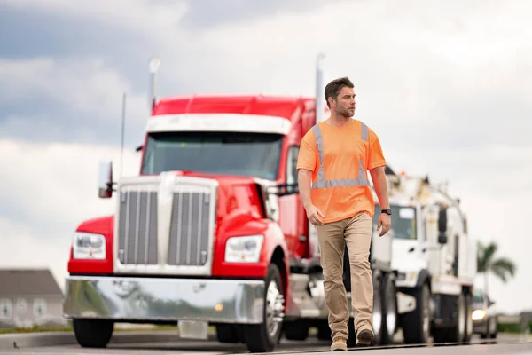 truck driver shows concept of logistics, copy space. truck driver represents logistics walking outdoor. photo of truck driver with logistics concept. truck driver represents logistics.