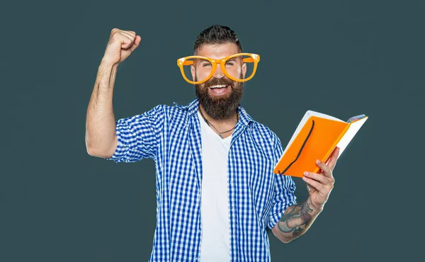 stock image successful funny bearded man in party glasses read book.