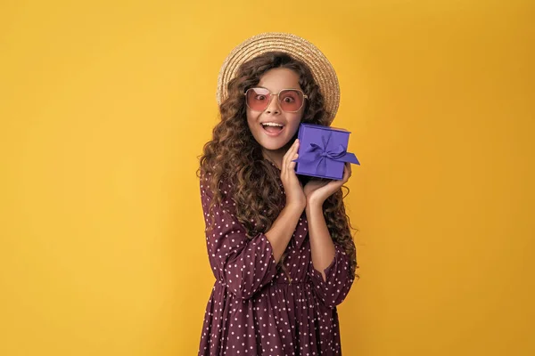 Happy Girl Curly Hair Hold Present Box Yellow Background — стоковое фото