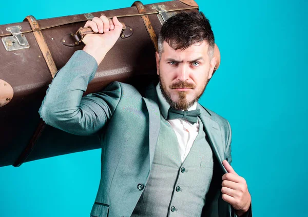 business trip with retro suitcase. stylish esthete with vintage bag. bearded man in formal suit. heavy bag. mature traveller. businessman in bow tie. Ready to new business trip. Stylish handsome man.