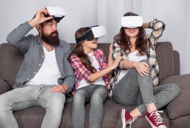 father mother and child wireless glasses. virtual reality family. happy parents with kid girl use modern technology. mom dad and daughter. digital future and innovation. modern life.