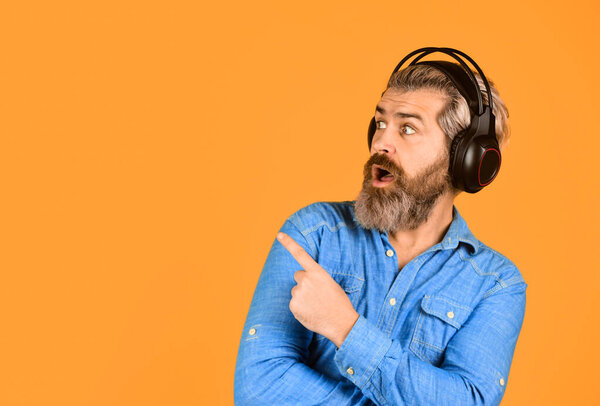Popular music playlist. Man bearded hipster headphones listening music. Singer on rehearsal. Hipster enjoy excellent sound song in earphones. Music beat. Noise cancelling function. Dj hipster.