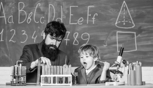 laboratory research and development. father and son at school. science camp. Chemistry beaker experiment. Back to school. teacher man with little boy. School education. Innovating for a Safer World.