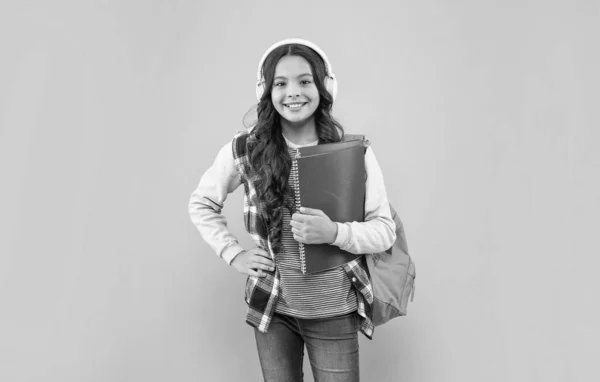 Positive Kid Listening Music Earphones School Bag Workbook Pink Background — Stock Photo, Image